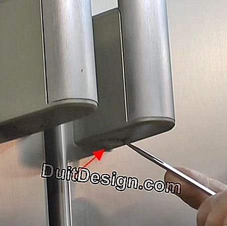 To access the lower screw for holding the handle, unclip the cover that conceals the screw.